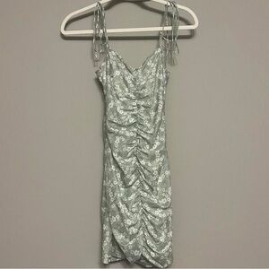 Light green body con ruched dress with white floral pattern